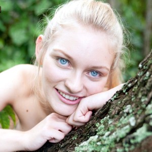 Blue eyed light-haired teen Alli Rae demonstrates her humungous titties outdoors in a thong and OTK socks