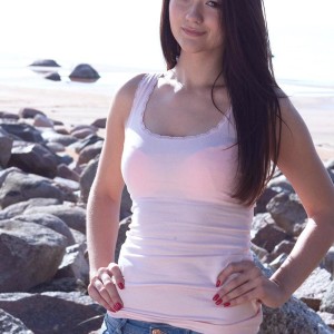Lil' brown-haired first-timer Olivia touting pointy teen boobies outdoors on rocky beach