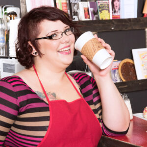 Redheaded big woman Kitty McPherson sports short hair and glasses while getting naked in a eatery