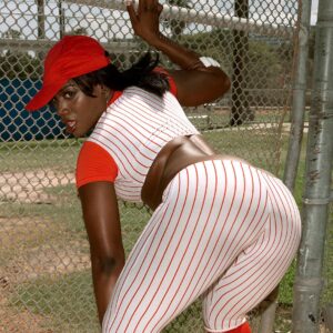 Black female Kali Dreams letting her huge ass loose from a baseball uniform while outdoors