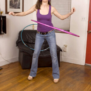 Brown-haired teener Ann Parker works a hula hoop before getting buck naked to fuck