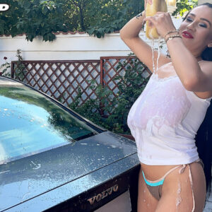 Gangly dark haired Helen Starlet releases her gigantic boobs while getting wet during a car wash