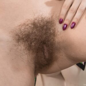 Brown-haired Euro female Gerda May exposes her hairy cooter and tiny breasts while in ponytails