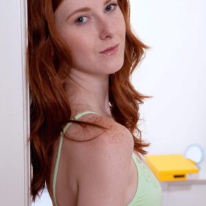 Young looking redhead strips totally naked in a safe for work manner