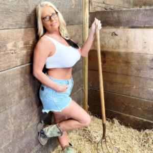 Light-haired first-timer Maddie Cross unsheathes her hefty titties while getting naked in a horse stall