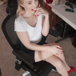 Blonde amateur finger spreads her trimmed pussy after disrobing at a desk