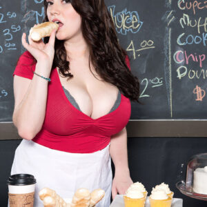 Black-haired female Kate Marie uncovers her big breasts while disrobing in a coffee shop