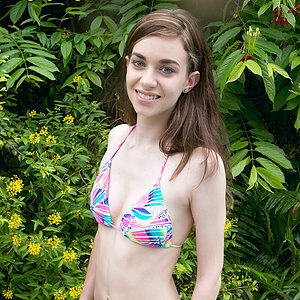 Hot teen Tali Dova releases her small tits from a bathing suit before getting in a pool
