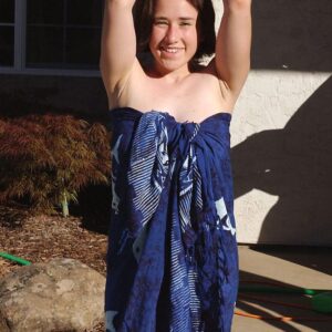 Dark haired girls show their hairy underarms and beavers in a yard