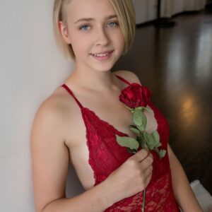 Young blonde takes off red lingerie to get totally naked