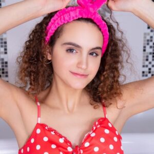 Petite teen with curly hair Kiera takes off a dress before prior to a bubble bath