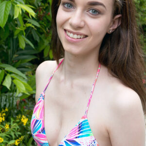 Hot teen Tali Dova frees her tiny tits from a bathing suit before getting in a pool