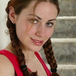 Amateur girl with braided pigtails displays her petite bosom and natural pussy
