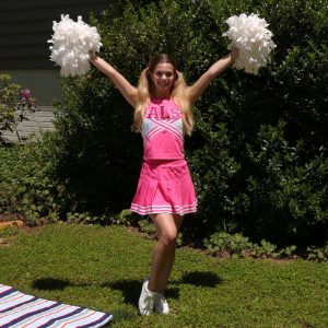 Teen cheerleader Molly Little displays her flexibility while naked in a backyard