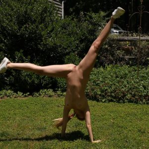 Teen cheerleader Molly Little displays her flexibility while naked in a backyard