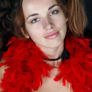 First timer Natalia covers herself in a red feather boa while otherwise naked