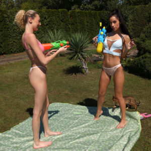 Lesbian lovers Kama Oxi and Isabella De Laa have sexual relations in a yard